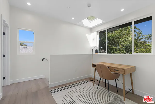 a bedroom with a large bed and a chair