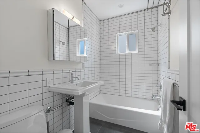 a view of a street with potted plants