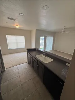 a kitchen with a sink and a stove top oven