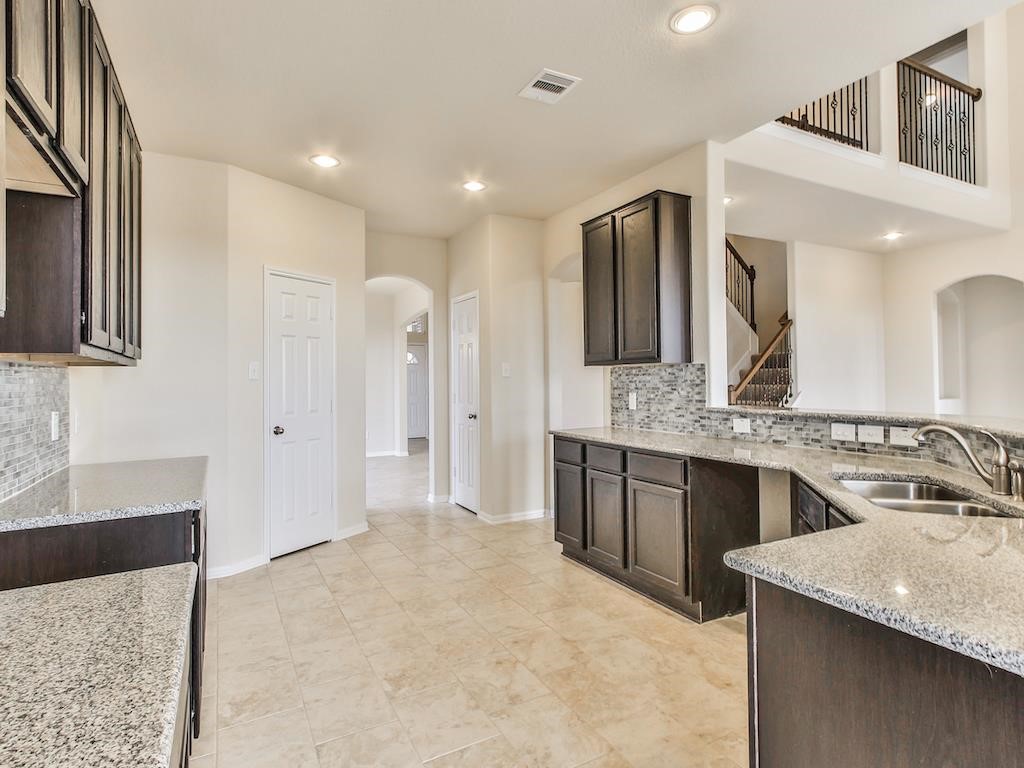 4615 Russet Leaf Trace Katy, TX 77449 - Photo 5 of 32 a bathroom with a granite countertop sink a large mirror and a shower