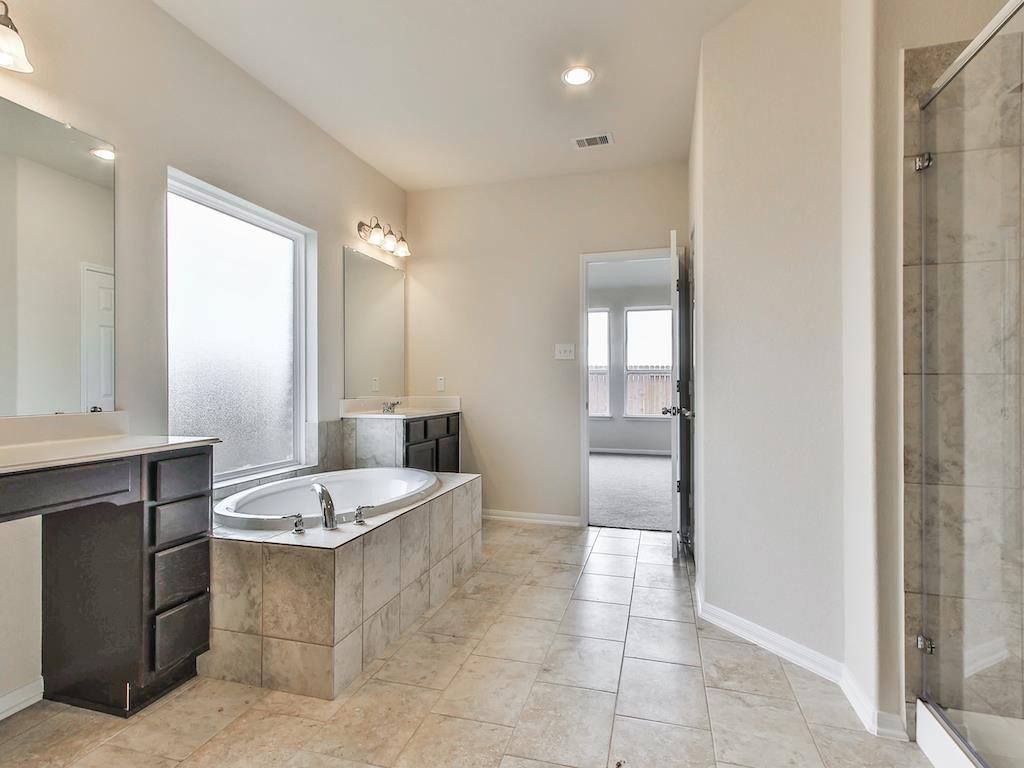 4615 Russet Leaf Trace Katy, TX 77449 - Photo 9 of 32 a bathroom with a granite countertop sink and a mirror