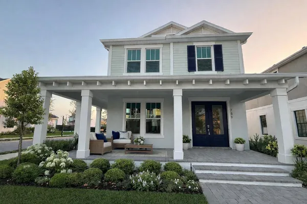 a front view of a house with a yard outdoor seating and garden