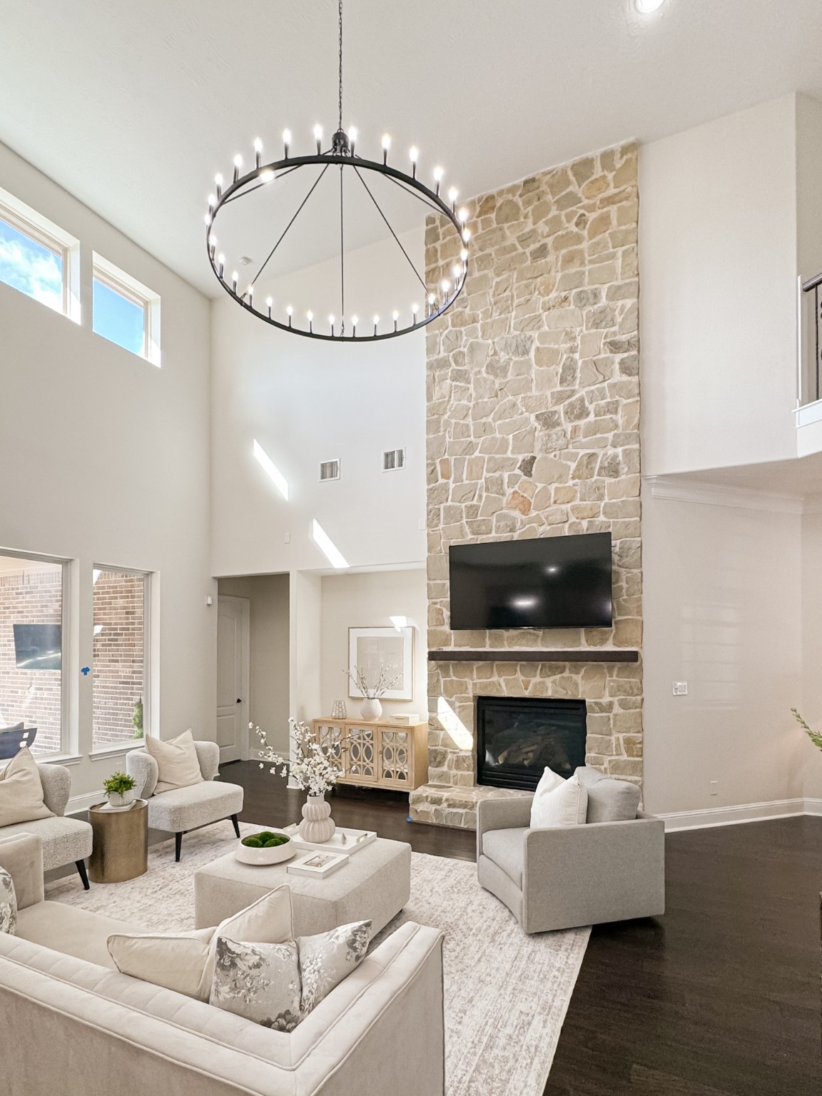 5815 Mustang Ridge Lane Fulshear, TX 77441 - Photo 13 of 50 a living room with furniture a fireplace and a chandelier