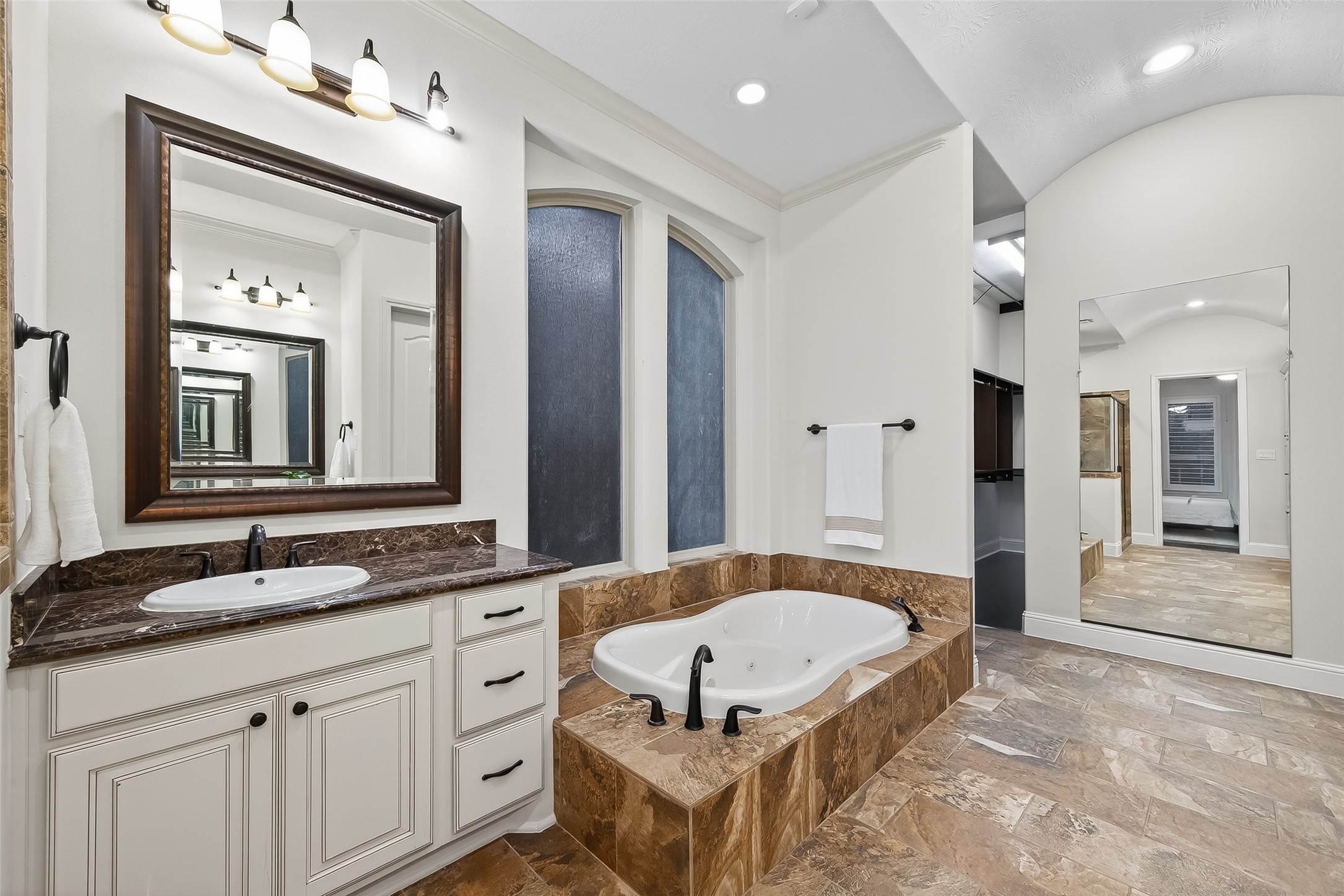 5815 Mustang Ridge Lane Fulshear, TX 77441 - Photo 23 of 50 a bathroom with a tub a double vanity sink and mirror