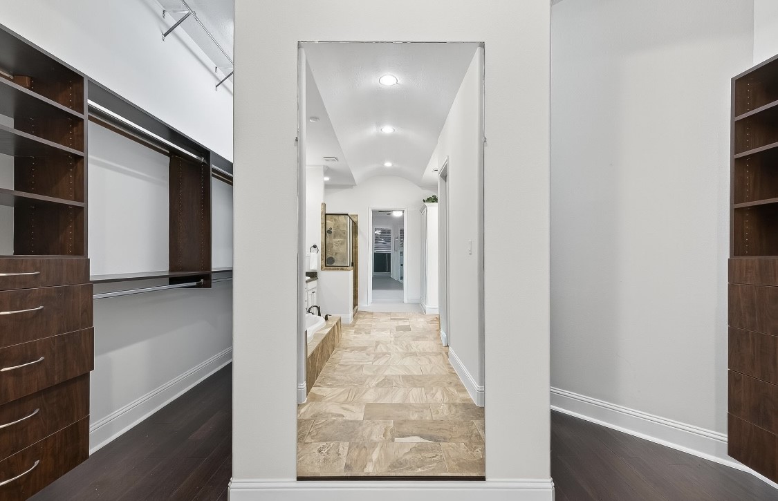 5815 Mustang Ridge Lane Fulshear, TX 77441 - Photo 26 of 50 a view of a hallway with wooden shelves