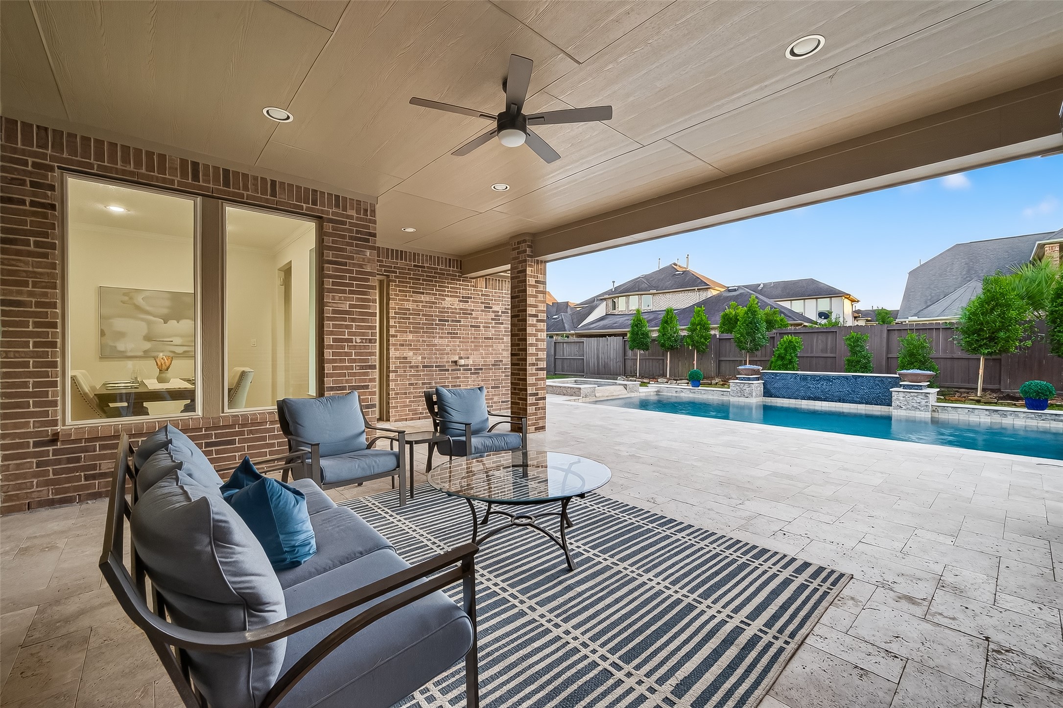 5815 Mustang Ridge Lane Fulshear, TX 77441 - Photo 42 of 50 a living room with furniture and a floor to ceiling window