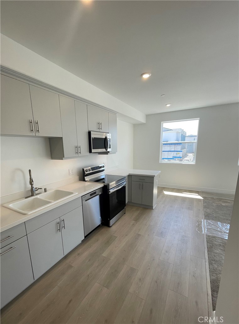 935 Madonna Road, Unit 204 San Luis Obispo, CA 93405 - Photo 1 of 1 a kitchen with granite countertop white cabinets and white appliances