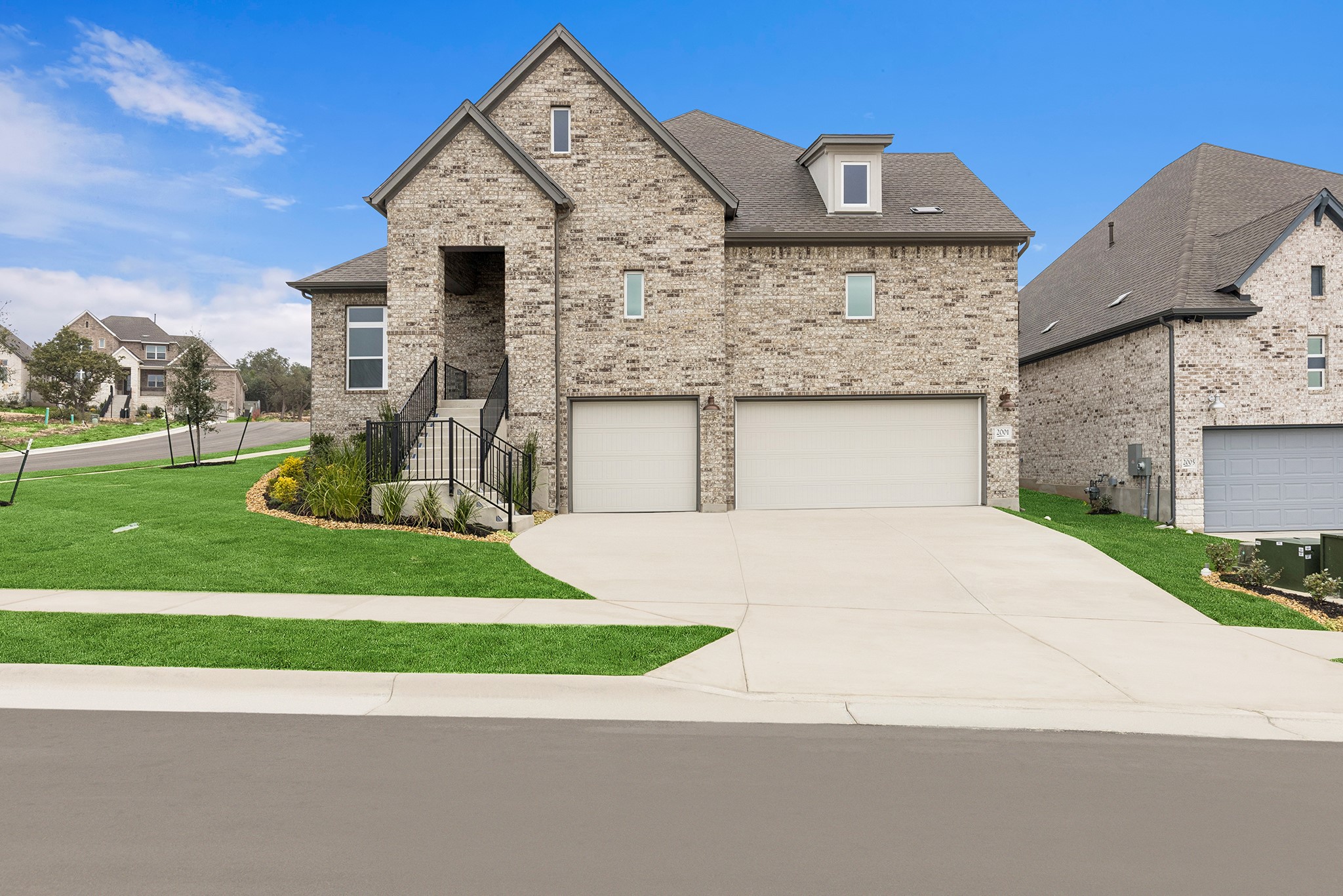 a front view of a house with a yard and garage