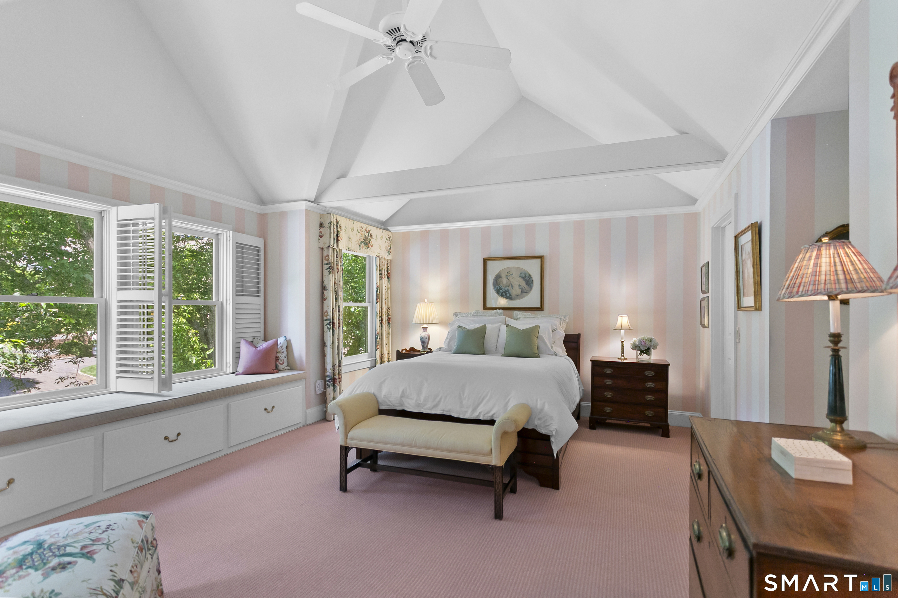 936 South Pine Creek Road Fairfield, CT 06824 - Photo 18 of 39 Primary bedroom en-suite with vaulted ceiling, beams, built-in window seat, walk in closet and full bath.