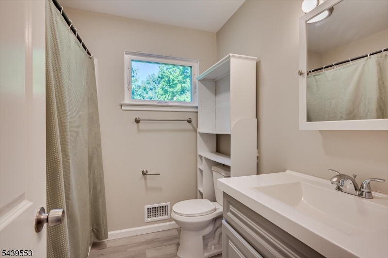 15 Woodmere Street Raritan, NJ 08869 - Photo 12 of 16 a bathroom with a sink toilet and a mirror