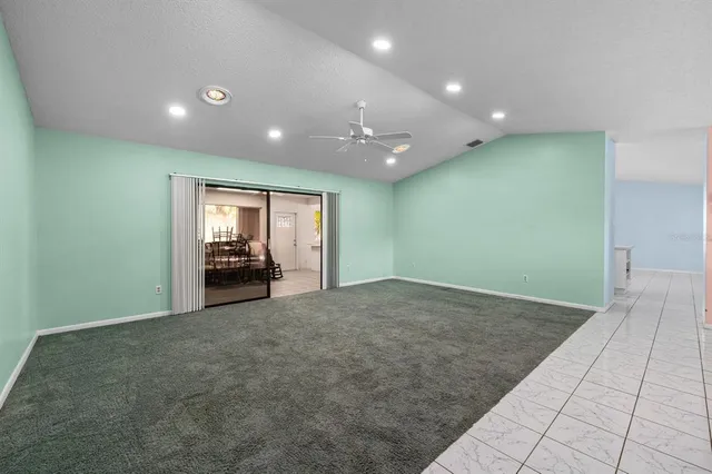 a view of an empty room with window and fire place