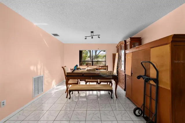 a dining room with furniture and window