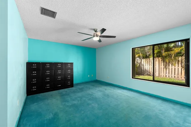 an empty room with windows and closet