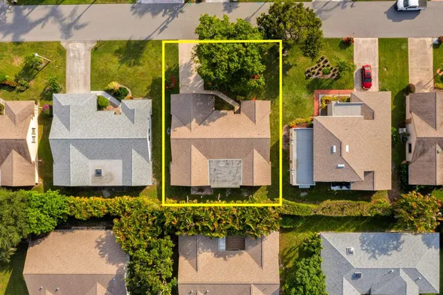 an aerial view of a house with a yard