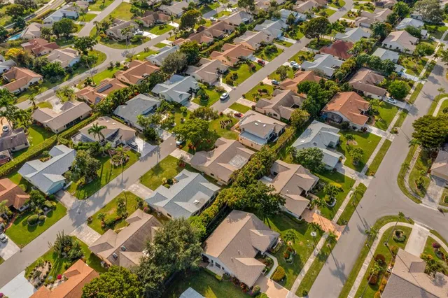 an aerial view of residential houses with outdoor space