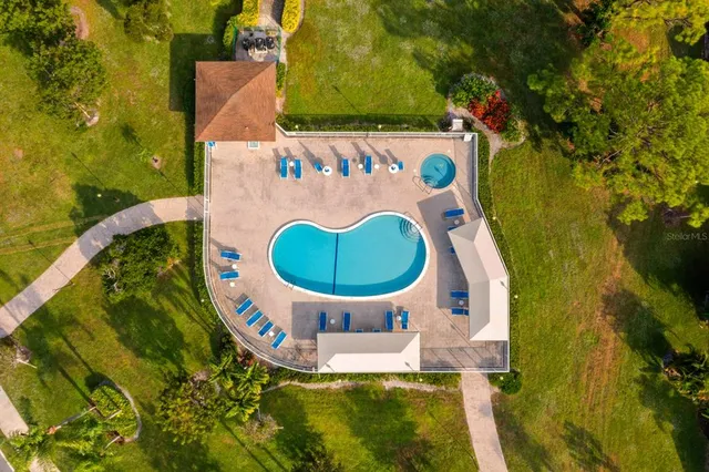 a view of a swimming pool with a yard