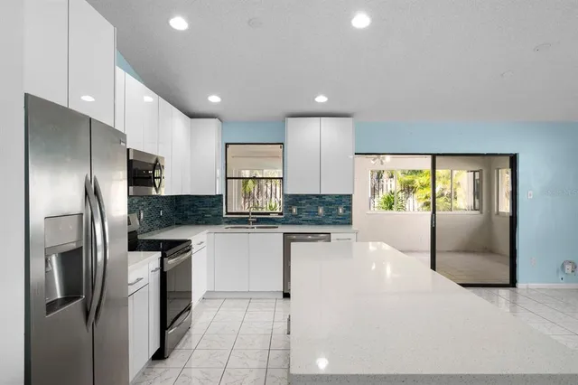 a kitchen with stainless steel appliances a refrigerator sink and stove