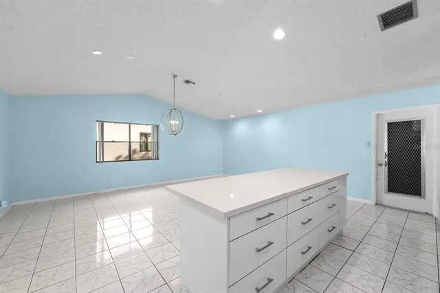 a kitchen with a stove a sink and a refrigerator