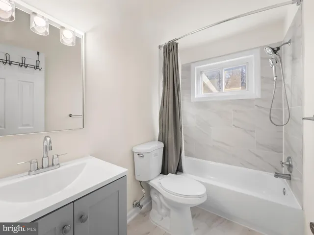 a front view of a house with a garden and plants