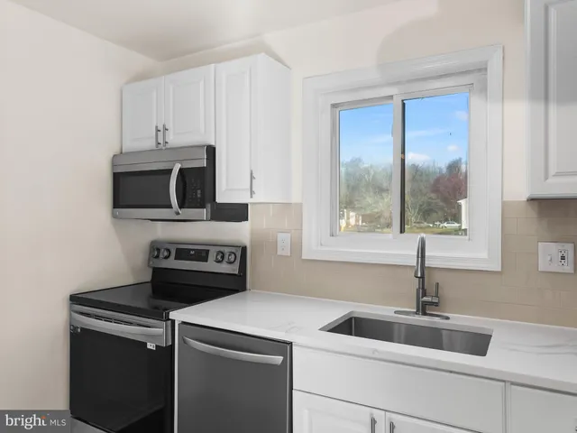 a kitchen with a stove and a sink