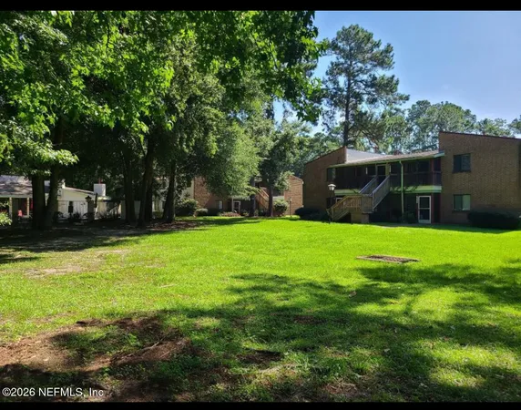 a view of house with backyard