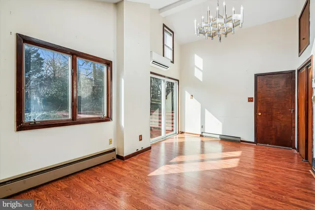 a view of a room with wooden floor
