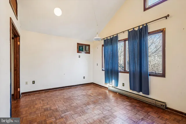 a view of a house with a small yard and wooden floor