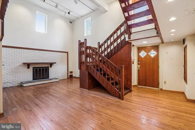 a view of an entryway with wooden floor and a hallway