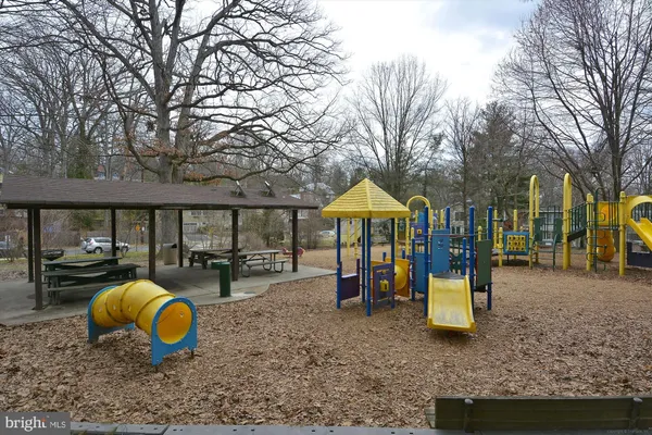 a view of a park with swings and slides