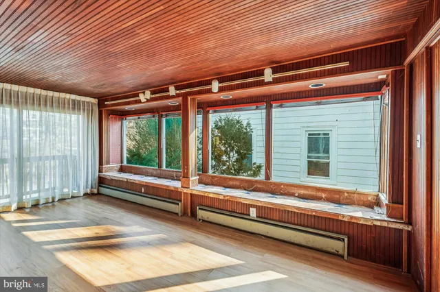 a bathroom with a granite countertop sink a mirror and a shower