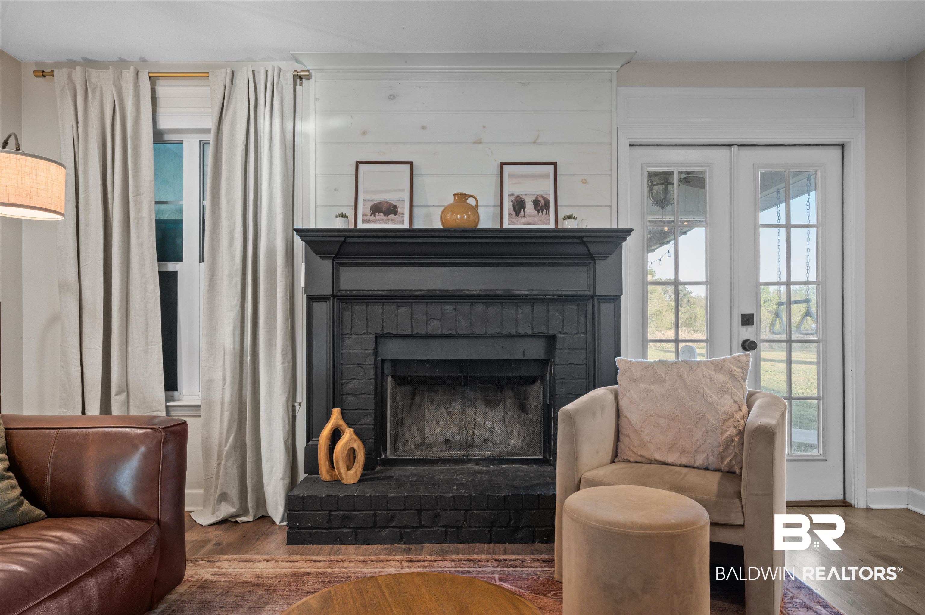 22370 Buck Road Robertsdale, AL 36567 - Photo 10 of 31 Living area featuring baseboards, wood finished floors, french doors, and a brick fireplace