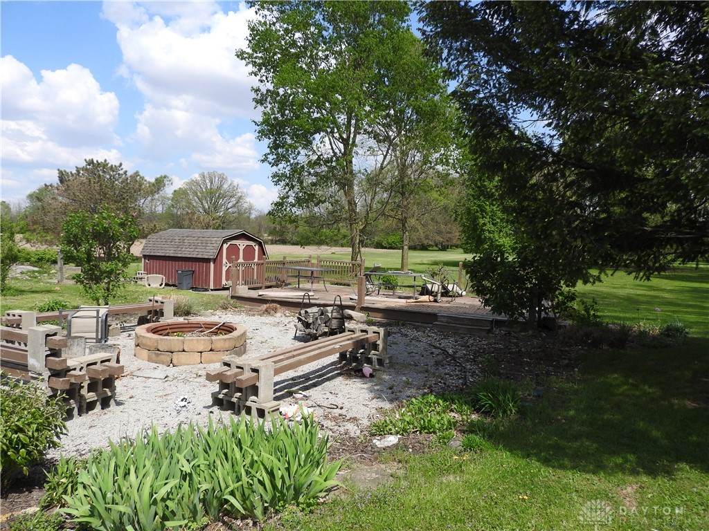 2105 East Loy Road Piqua, OH 45356 - Photo 7 of 26 This spacious yard features a charming shed, a relaxing deck, and a cozy fire pit.