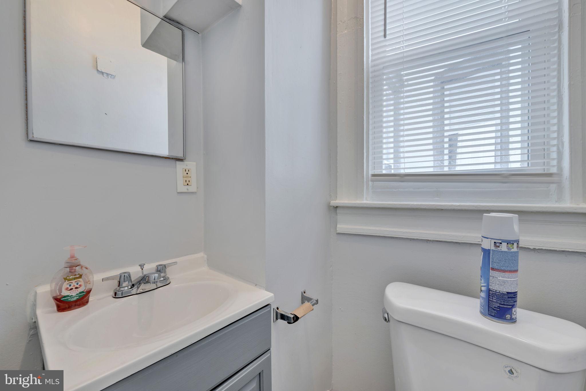 2822 Riggs Avenue Baltimore, MD 21216 - Photo 8 of 30 a bathroom with a sink and a window