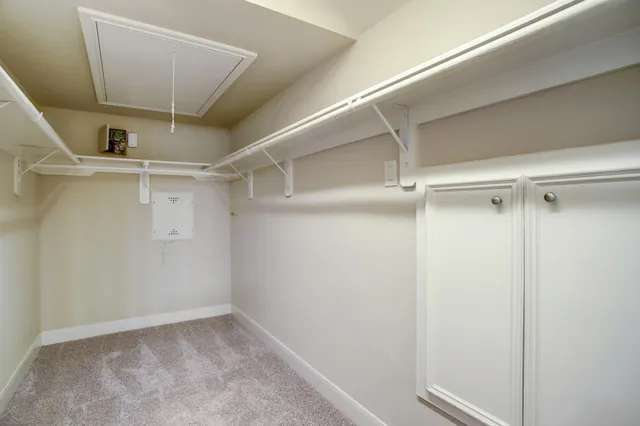 a spacious bathroom with a granite countertop sink a mirror and shower