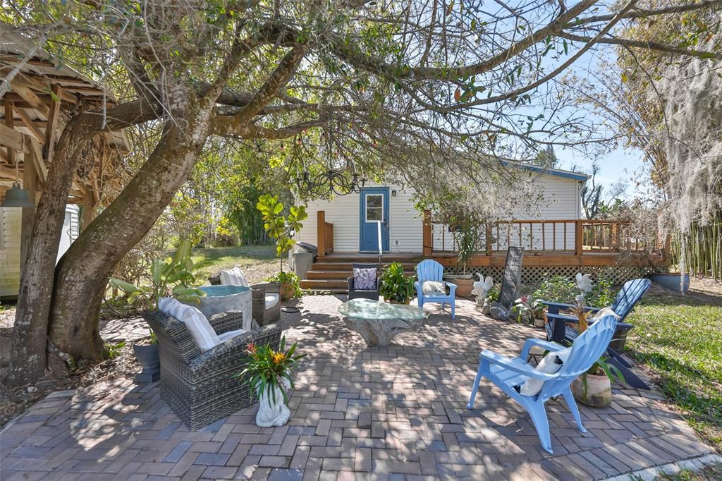 20112 Hobbs Road Wimauma, FL 33598 - Photo 7 of 94 a view of a patio with table and chairs with wooden fence and large trees