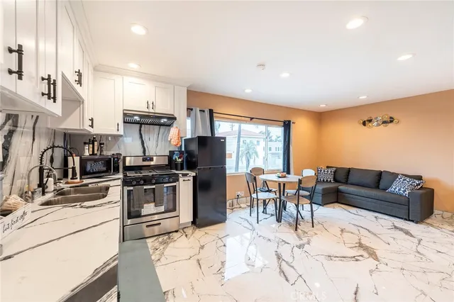a kitchen with stainless steel appliances kitchen island granite countertop a sink and cabinets