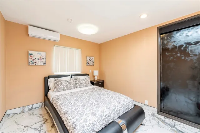 a bedroom with a bed and a wall painting