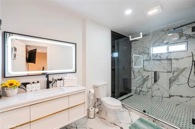 a bathroom with a sink toilet and shower