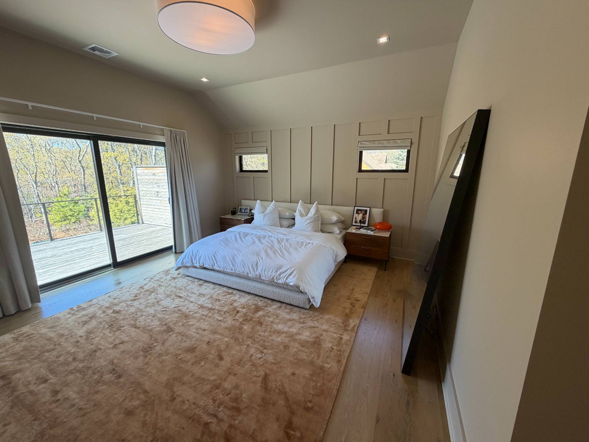 62 Whooping Hollow Road East Hampton, NY 11937 - Photo 11 of 31 a bedroom with a large bed and a large window