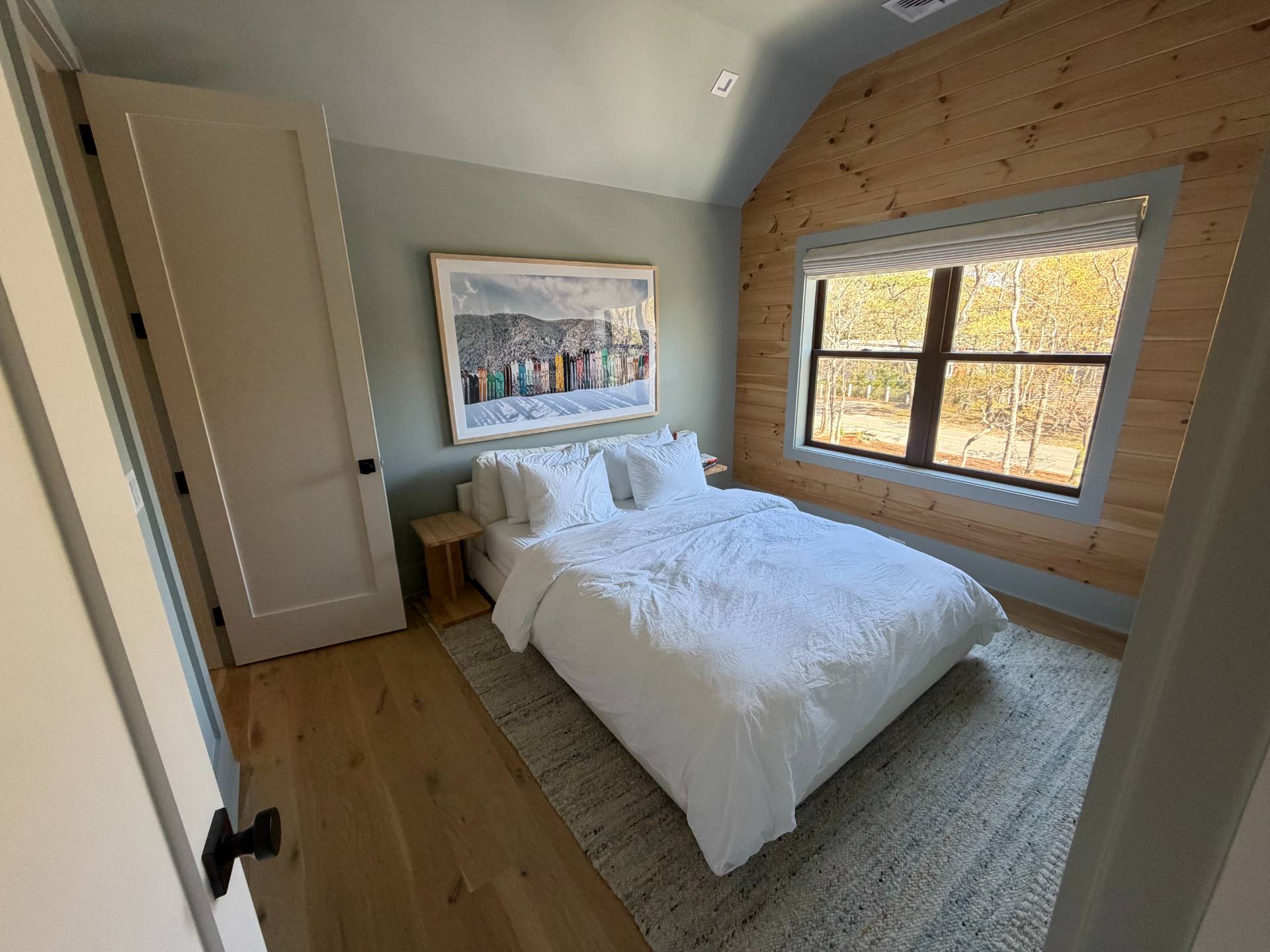 62 Whooping Hollow Road East Hampton, NY 11937 - Photo 16 of 31 a bedroom with a bed and a window