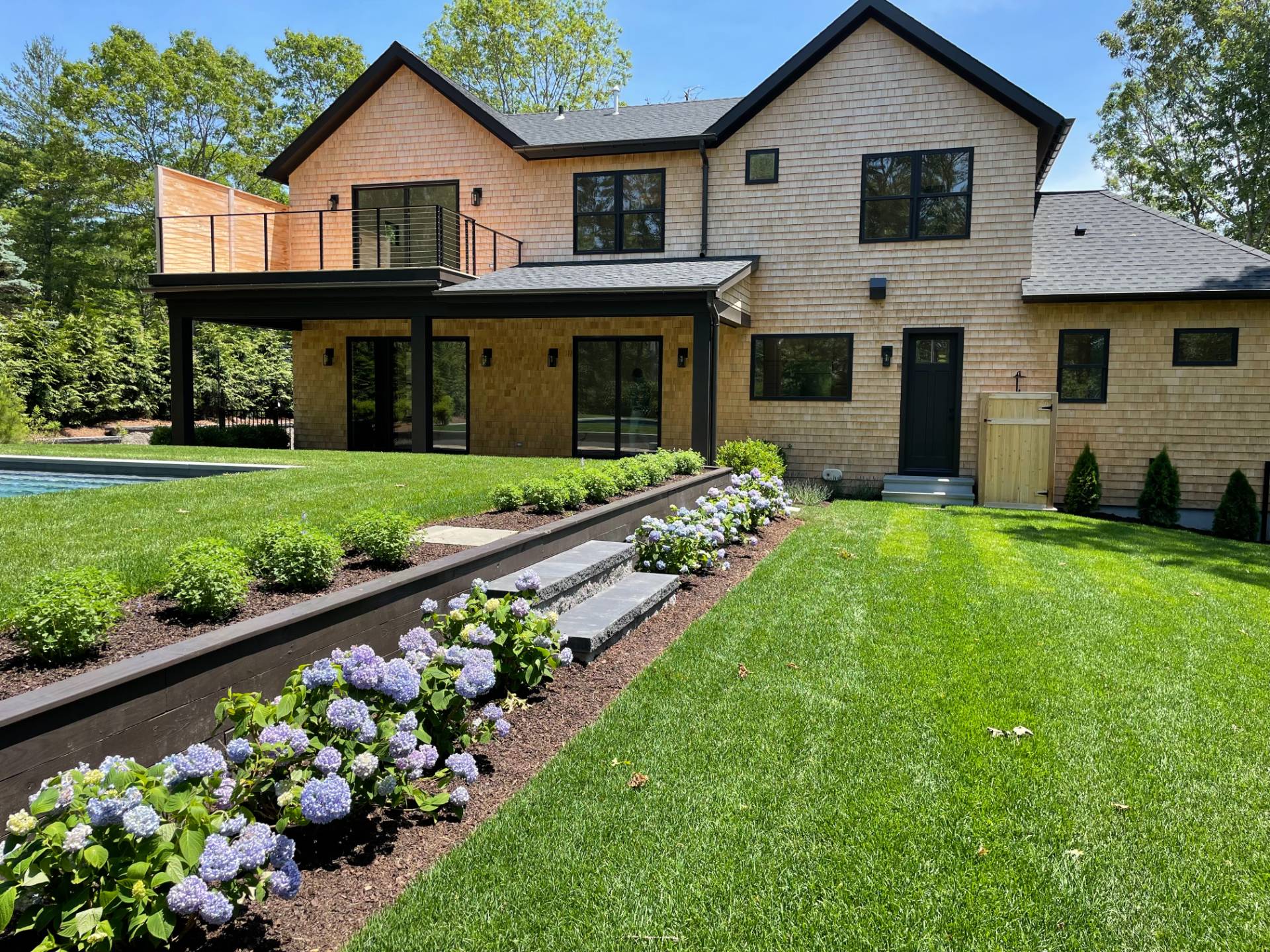62 Whooping Hollow Road East Hampton, NY 11937 - Photo 27 of 31 a front view of a house with a yard and potted plants