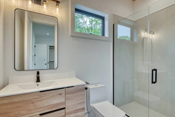 a bathroom with a toilet a sink and shower