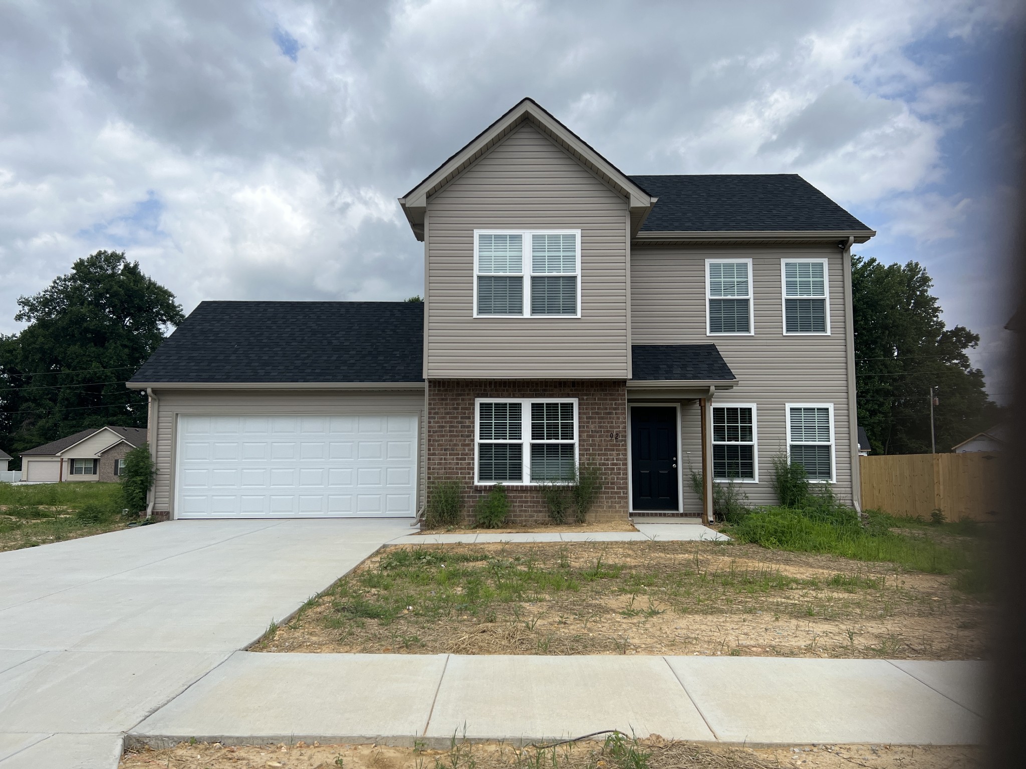 92 Timber Circle Manchester, TN 37355 - Photo 1 of 21 a front view of a house with garage and plants