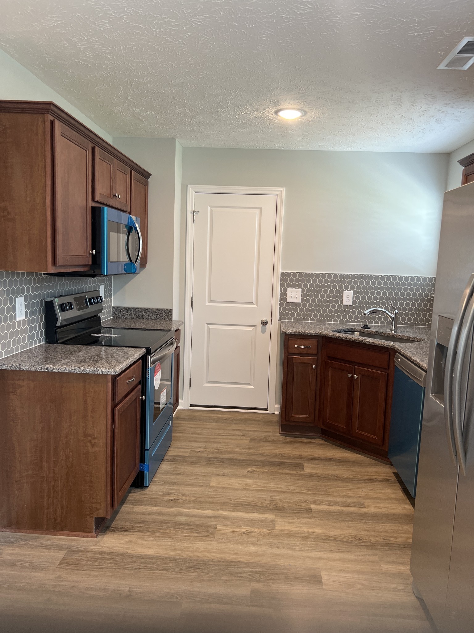 92 Timber Circle Manchester, TN 37355 - Photo 13 of 21 a kitchen with stainless steel appliances granite countertop a stove a sink and a refrigerator