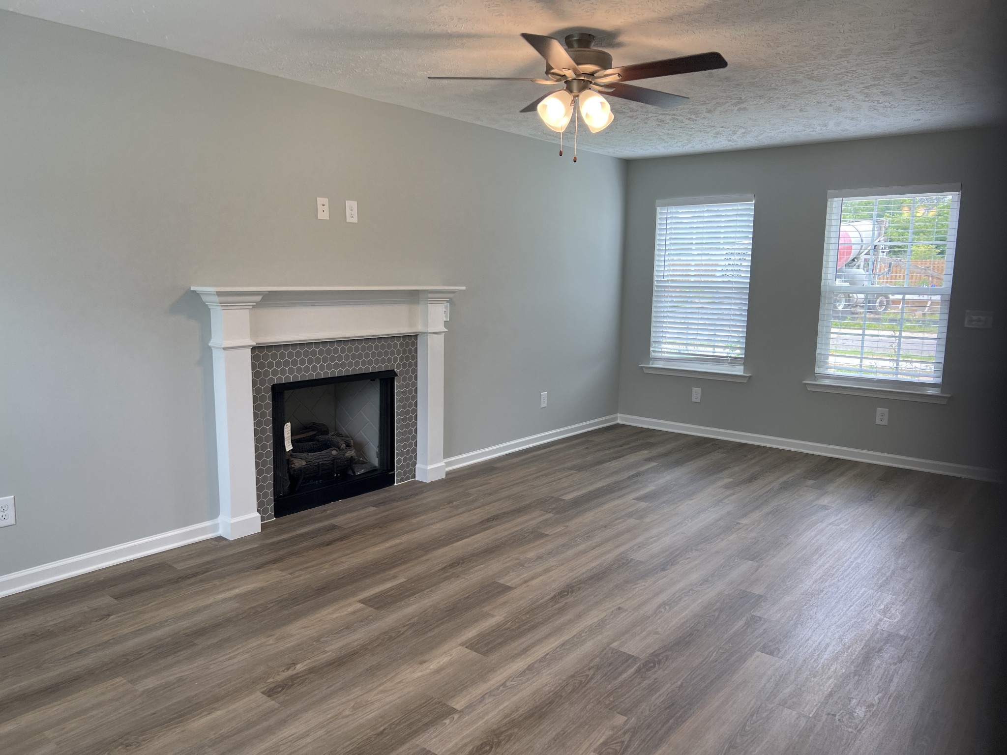 92 Timber Circle Manchester, TN 37355 - Photo 14 of 21 an empty room with wooden floor fireplace and windows