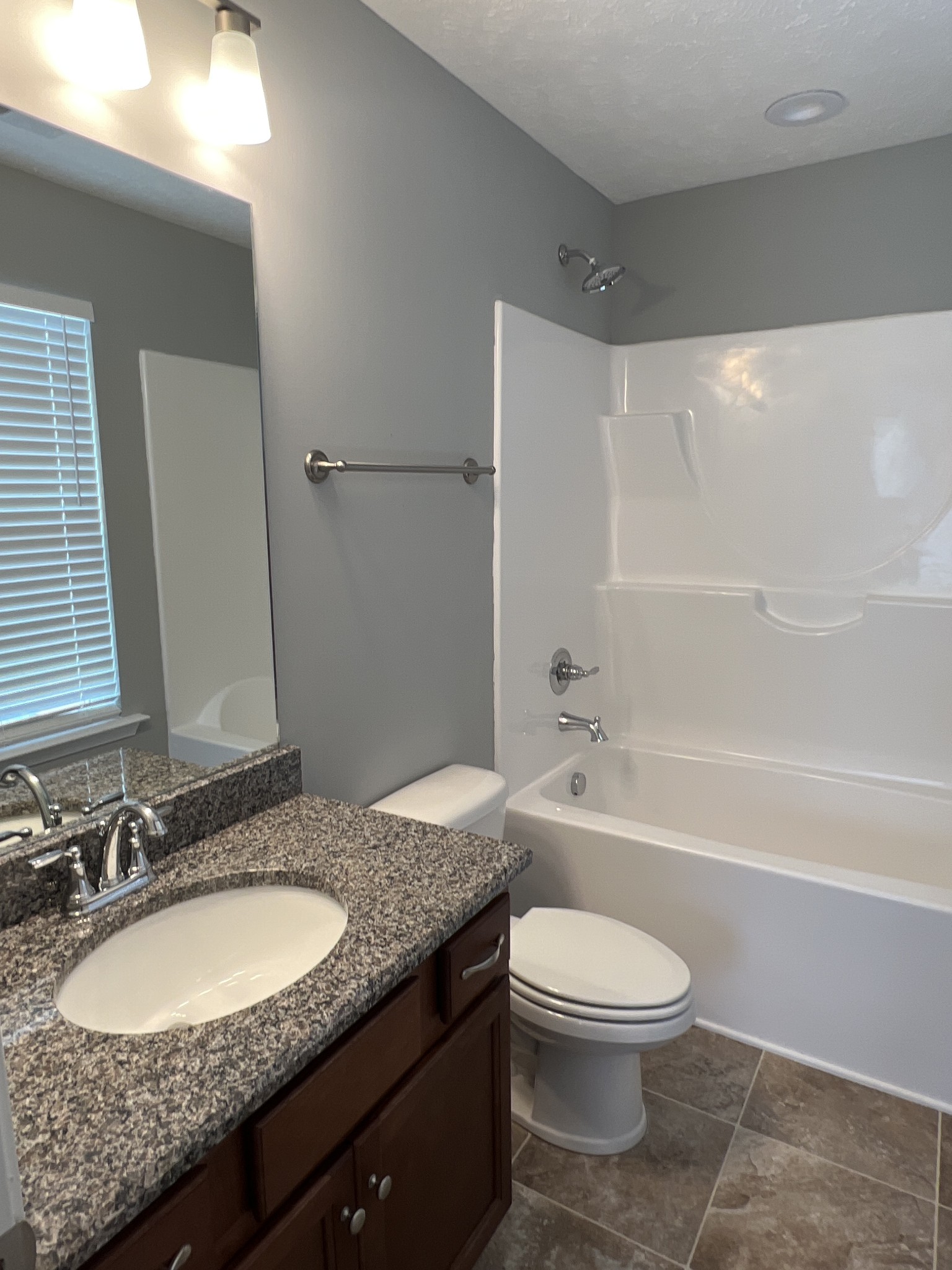 92 Timber Circle Manchester, TN 37355 - Photo 17 of 21 a bathroom with a granite countertop toilet a sink and a bathtub