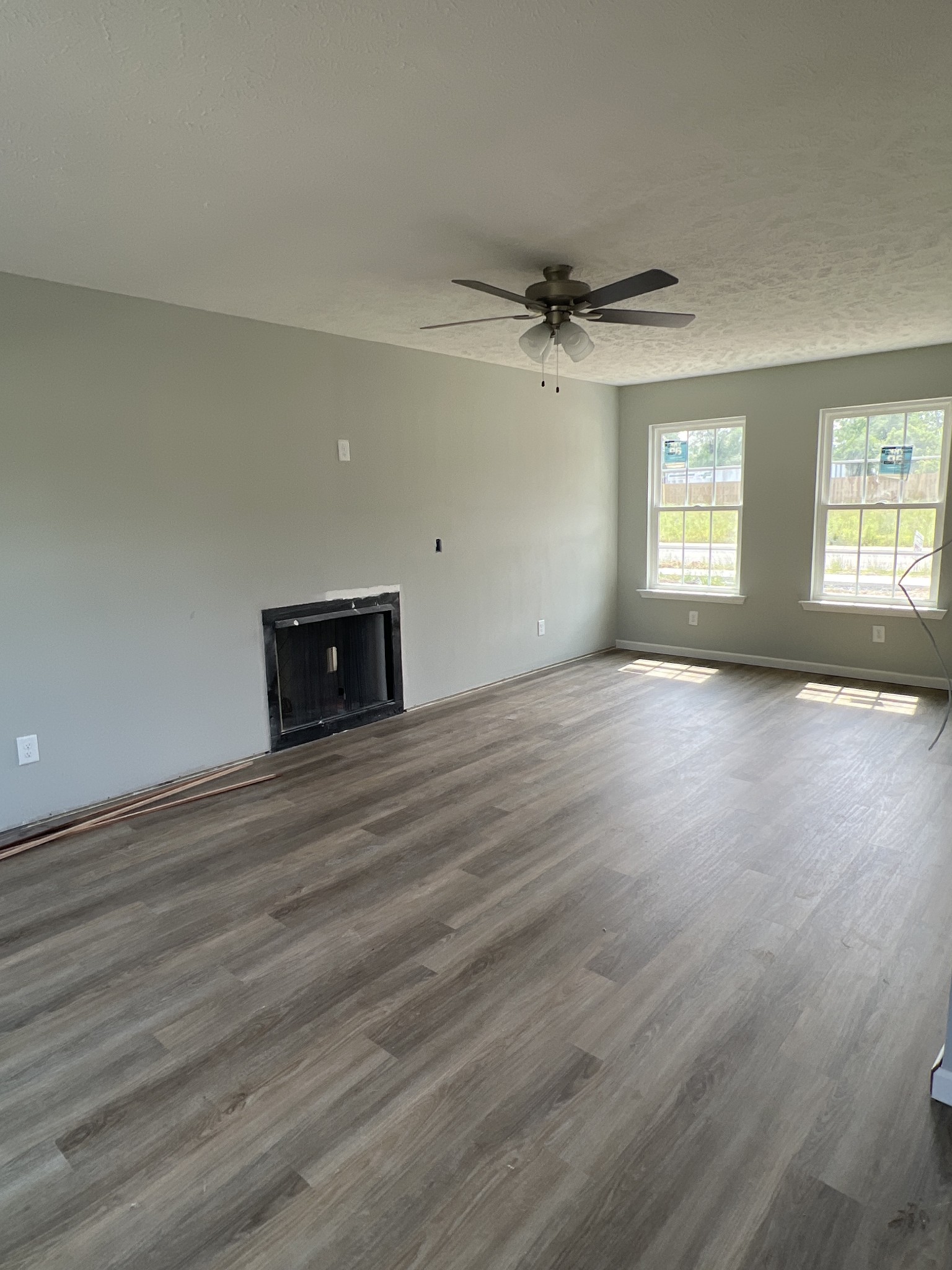 92 Timber Circle Manchester, TN 37355 - Photo 5 of 21 an empty room with wooden floor ceiling fan and windows