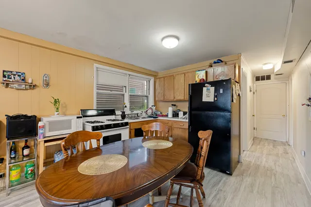 a dining room with furniture and wooden floor