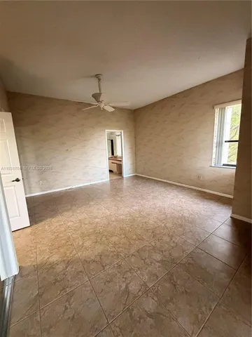 a bathroom with a granite countertop sink a toilet and mirror