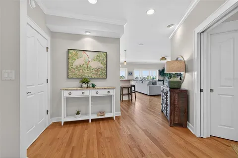 a dining room with wooden floor a glass table and chairs